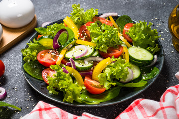 Fresh vegetables salad on black.