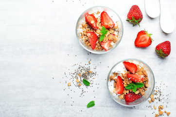 Tasty Strawberry Dessert, Homemade Yogurt with Strawberries, Granola and Chia Seeds over Bright Background