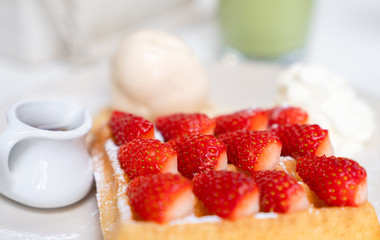 Closeup strawberry waffle with honey for topping