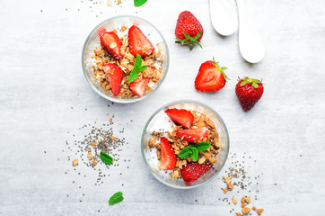 Tasty Strawberry Dessert, Homemade Yogurt with Strawberries, Granola and Chia Seeds over Bright Background