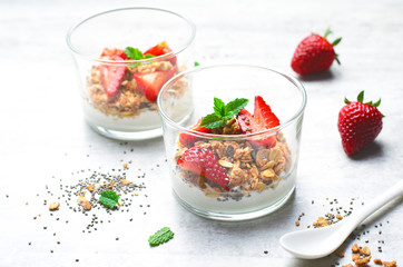 Tasty Strawberry Dessert, Homemade Yogurt with Strawberries, Granola and Chia Seeds over Bright Background