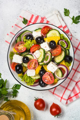 Greek salad in black plate on the table.