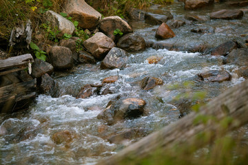 The mountain river flows through a rocky surface.