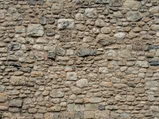 Old beige stone wall background texture. Part of a stone wall, for background or texture. Pattern...