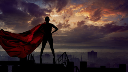 Portrait of young hero woman with super person red cape guard city - obrazy, fototapety, plakaty