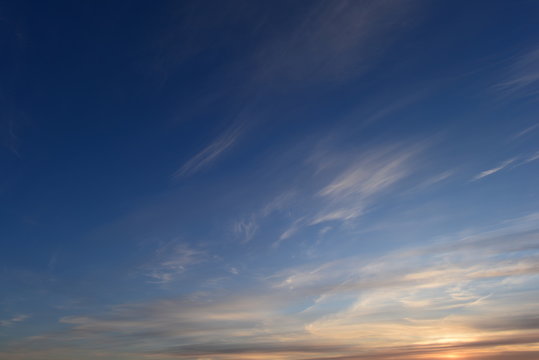 Brightly lit in sunset  blue sky in white cirrus clouds