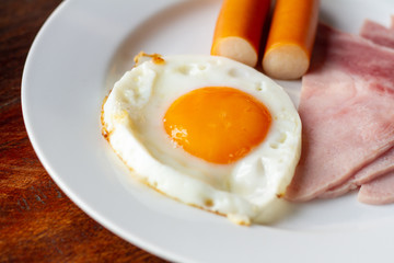 breakfast with fried egg, sausage, bacon