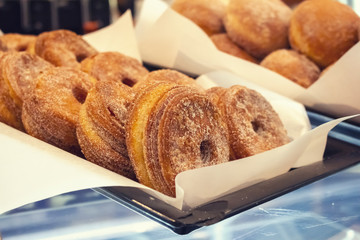 Several cronut desserts on display at a bakery
