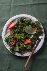 Vitamin salad with kale salad, basil, strawberry, raspberry and nuts