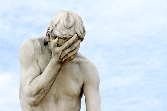 Facepalm - ashamed, sad, depressed. Statue with head in hand
