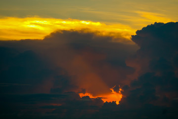 sunset sky back on dark silhouette cloud red lava hole of sun ray last light