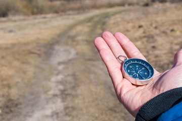 Tourist in the old road looking for a way with a compass