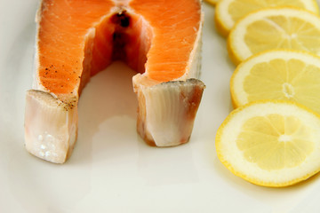 fresh salmon with lemon on plate