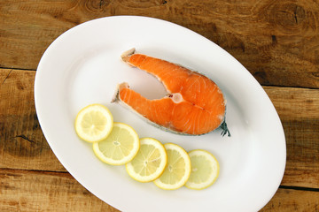fresh salmon with lemon on plate
