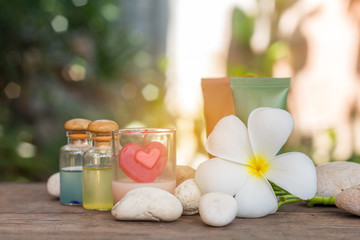 Aromatherapy product spa of therapy massage with plumeria or frangipani flowers, stones, aroma candle and oil on the desk,Spa treatment and skincare concept.