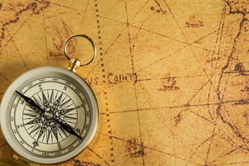 Golden compass on an old map. Selective focus