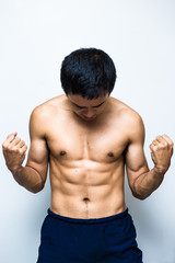 Fototapeta premium Smart and strong asian muscle man posting on white background