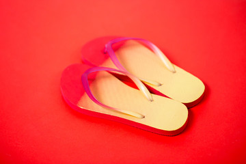 Beach flip flop on red background