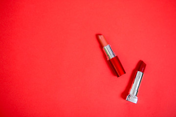 Lipstick isolated on red background
