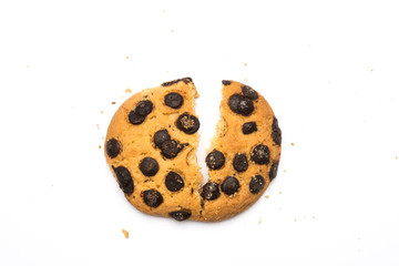 Broken handmade cookie with chocolate pieces and crumbs on white background