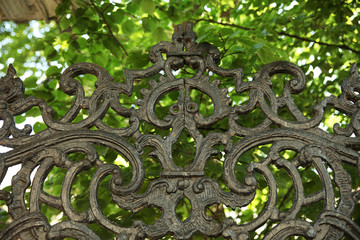 Upper part of the old real wrought iron fence painted with black paint