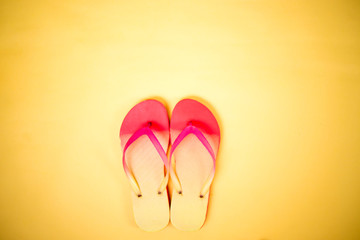 Beach flip flop on yellow background