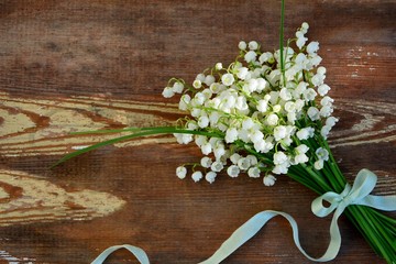 bouquet of lilies of the valley on a wooden background