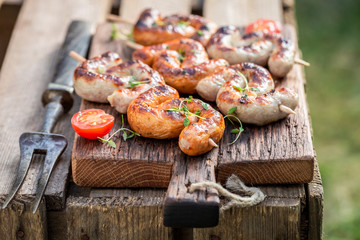 Crispy grilled sausage with spices in summer