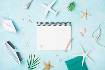 Fototapeta na wymiar Planning summer holidays, travel and vacation background. Empty notebook with accessories on blue pastel table top view. Flat lay style.