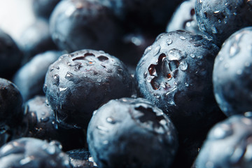 Nature background. Big beautiful water drops on ripe and juicy fresh picked blueberries closeup. Macro view of abstract nature texture and background organic pattern. Copy space. Macro shot