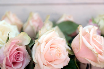 Pink roses on the wooden desk. Flat lay rose flower with leaves frame.