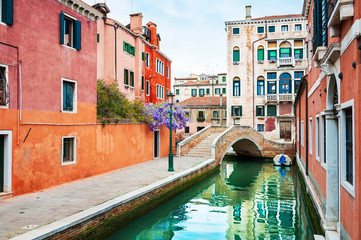 Fototapeta na wymiar Scenic canal with bridge and old architecture in Venice, Italy. Famous travel destination