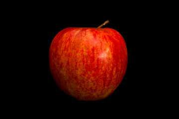 Fresh organic red apple isolated on black background.