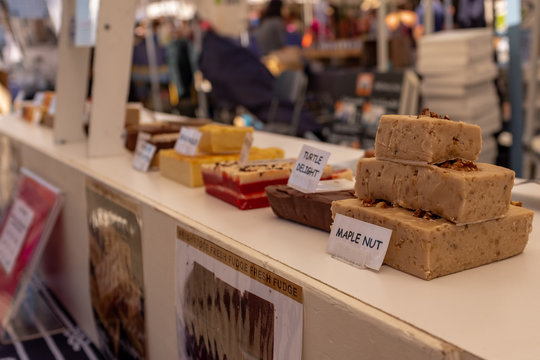 Homemade yummy looking fudge for sale at a Farmers Market, the foreground being Maple Nut, nobody in the image