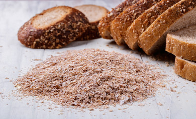 a handful of bran and pieces of bread on the table