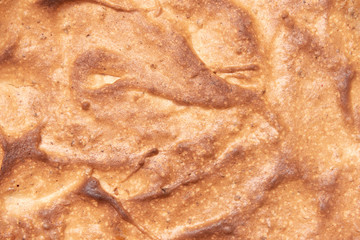 Close-up of a homemade sweet cake Top view, texture of baked whipped egg white crust.