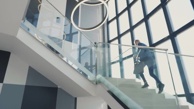 Businessman in hurry running fast upstairs