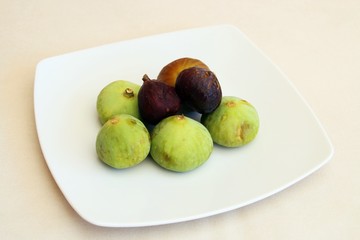 Plate of ripe black and white figs. The delicious fruit of the tree (Ficus carica).