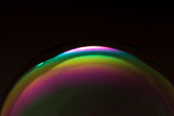 Vibrant soap bubble on black background
