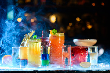 Set of classic cocktails in a smoke bar