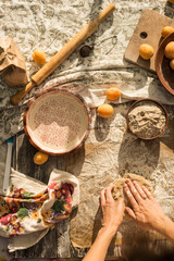 woman in gentle sundress cooking a sweet pie with fresh apricots on a sunny summer day
