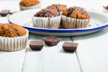 chocolate cupcakes, old white wooden table