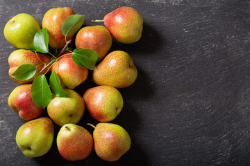 fresh pears on a dark table, top view