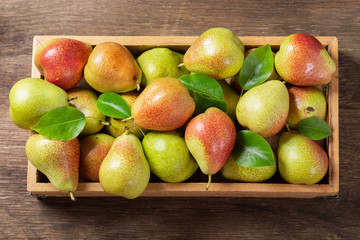 fresh pears in a wooden box, top view