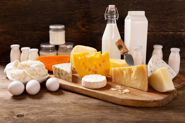 various types of dairy products on rustic wooden table