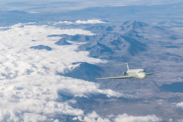 Fototapeta premium Commercial airplane flying above clouds