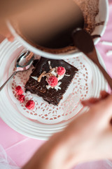 tasty homemade chocolate birthday cake decorated of some raspberries and candles served on the gentle pink background