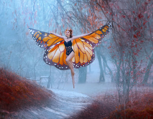A bright, positive monarch butterfly enjoys flying. A young woman with a perfect body, long legs...
