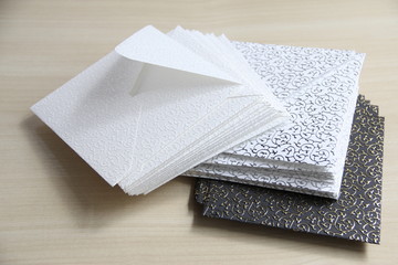 Black and white envelopes in a stack on the table