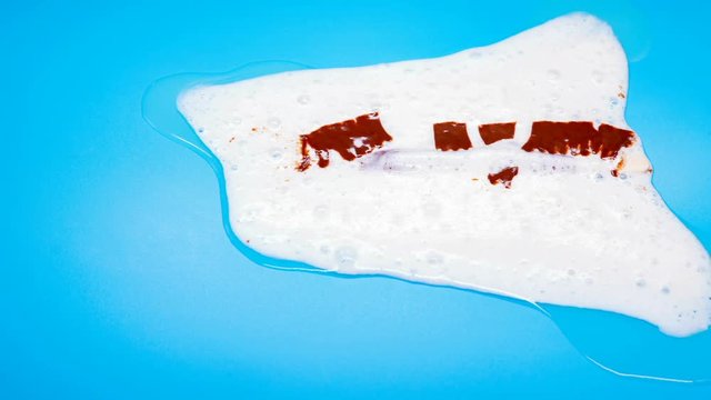 reverse of side view chocolate flavor popsicle melting on blue time lapse
